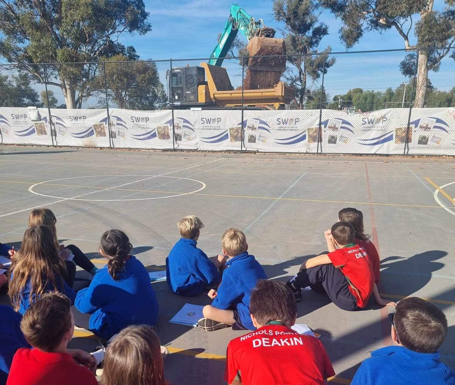 Nichols Point Primary School students watching the works unfold 